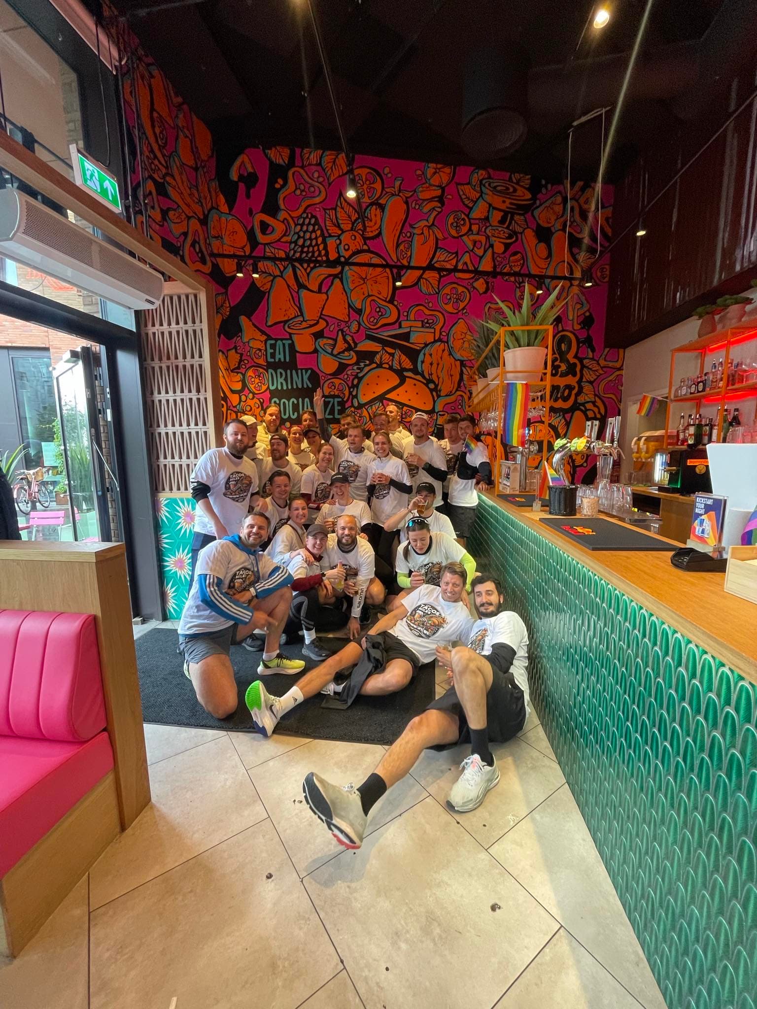 Runners gathered inside Los Tacos after the event